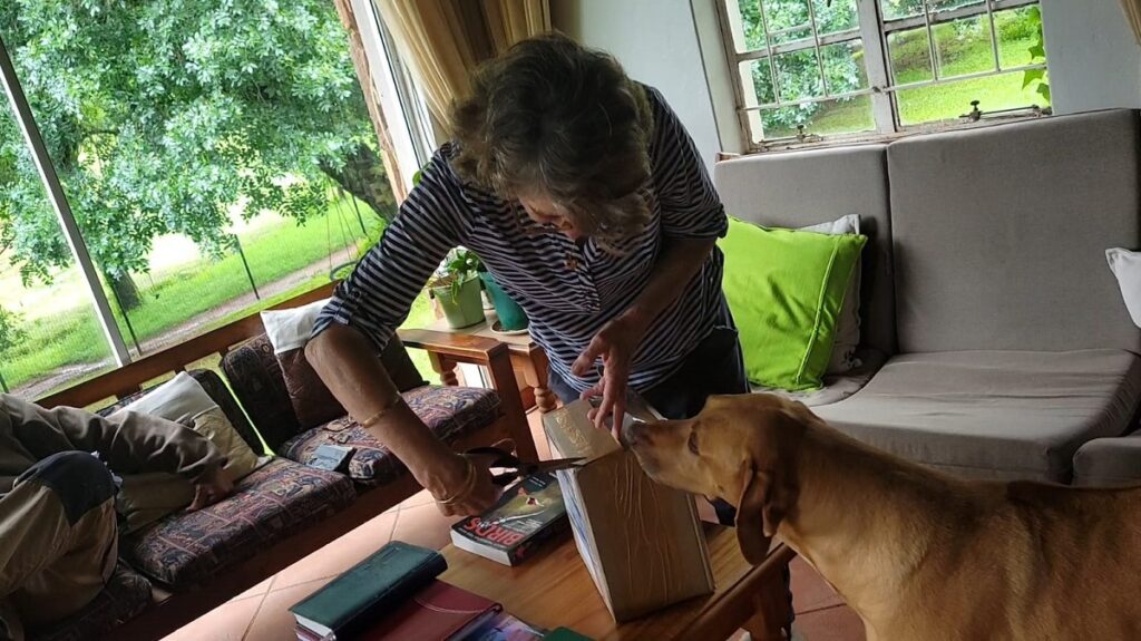 woman opening box of books